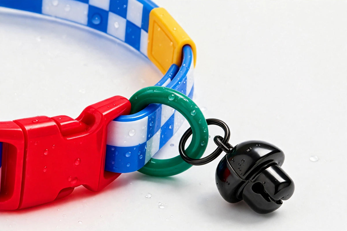 Close-up of checkered cat collar band, buckle and bell with water droplets