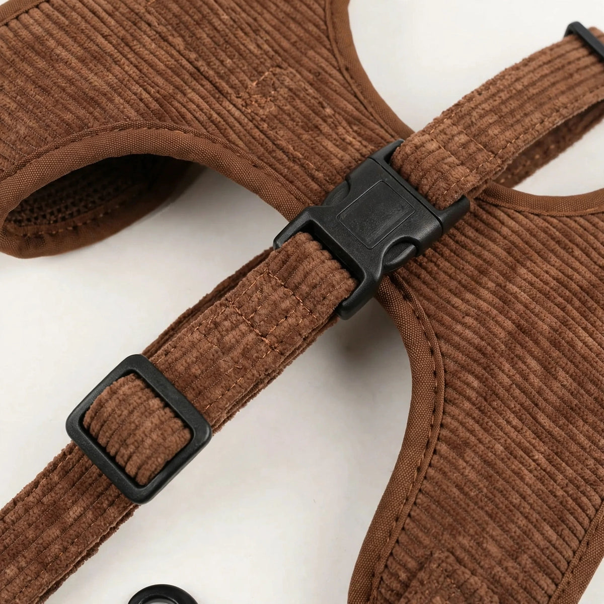 Close-up of brown corduroy fabric texture, buckle and stitching