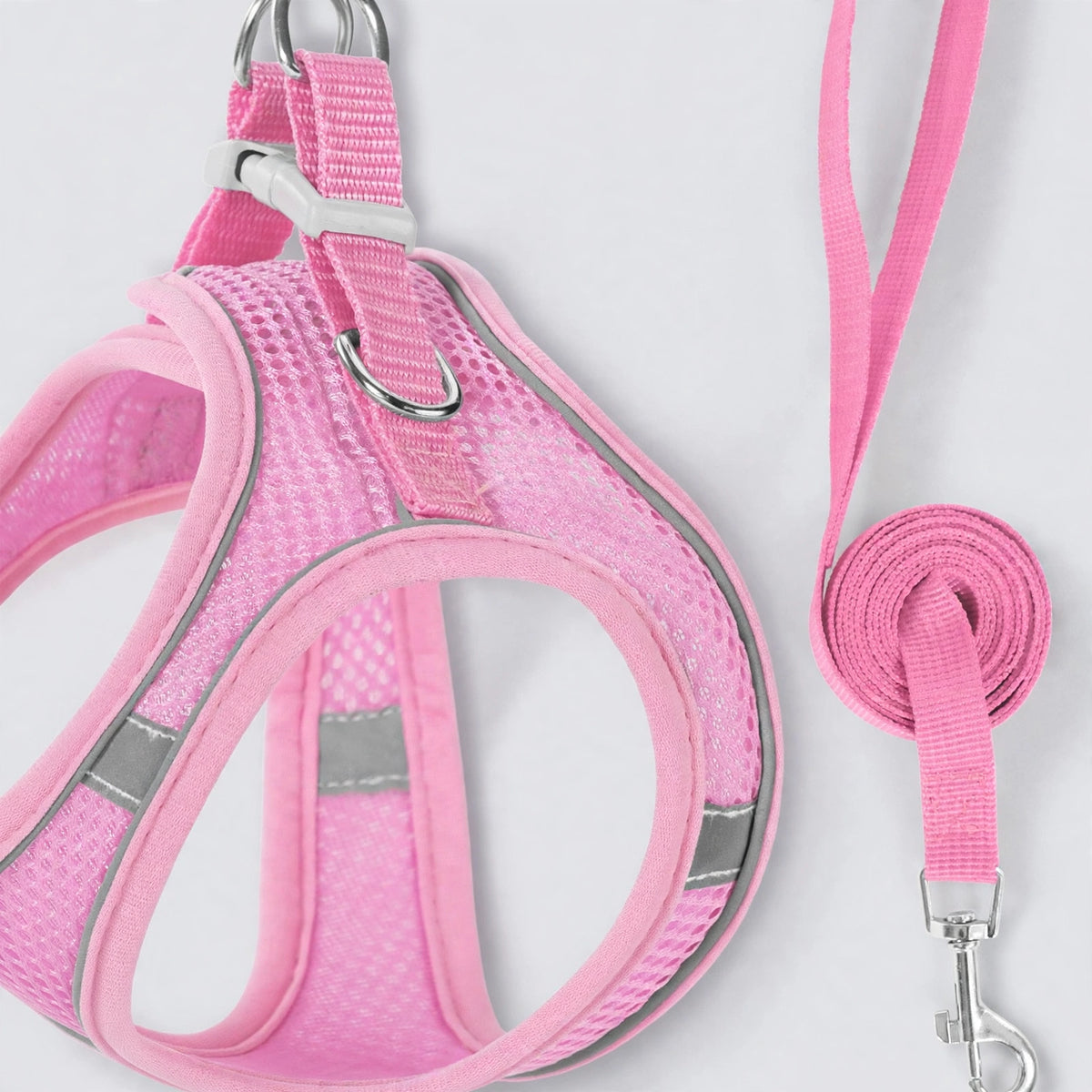 Close-up of pink mesh fabric and reflective strips on dog harness