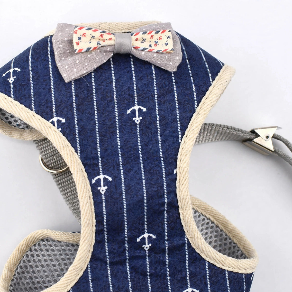 Close-up of bow tie and navy anchor-print fabric on plaid vest harness